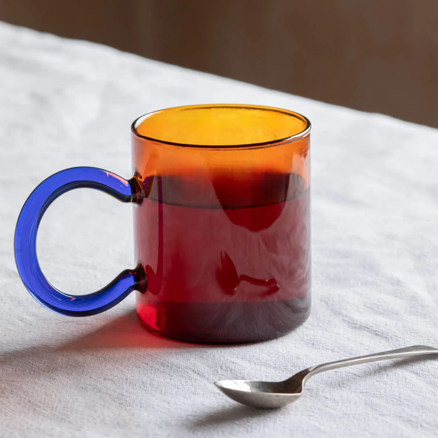 Graham & Green Amber Glass Mug with Blue Handle